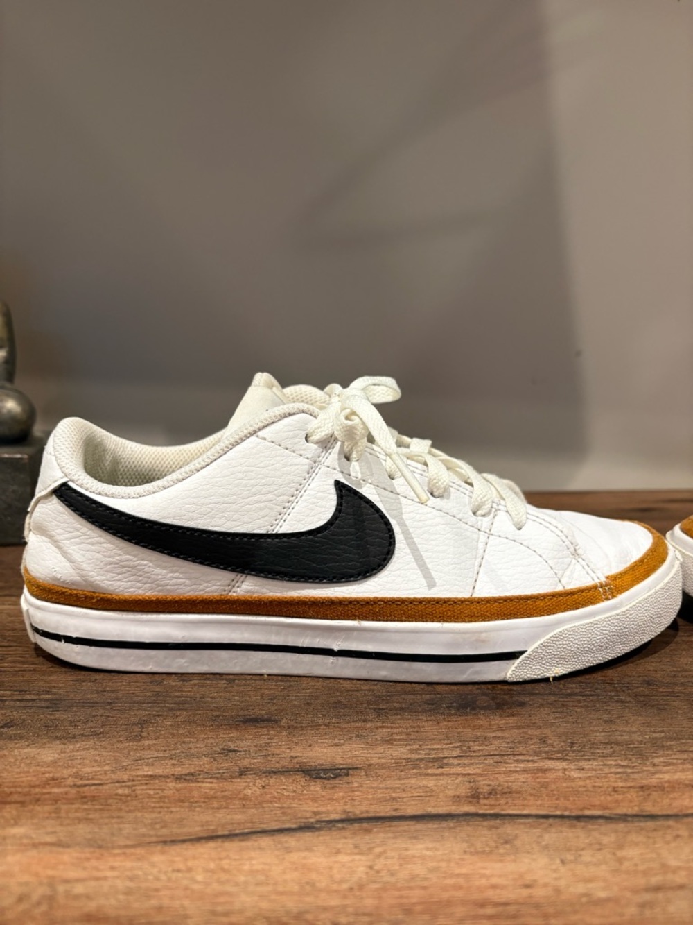 Nike White Low-Top Sneakers with Black Swoosh and Brown Trim